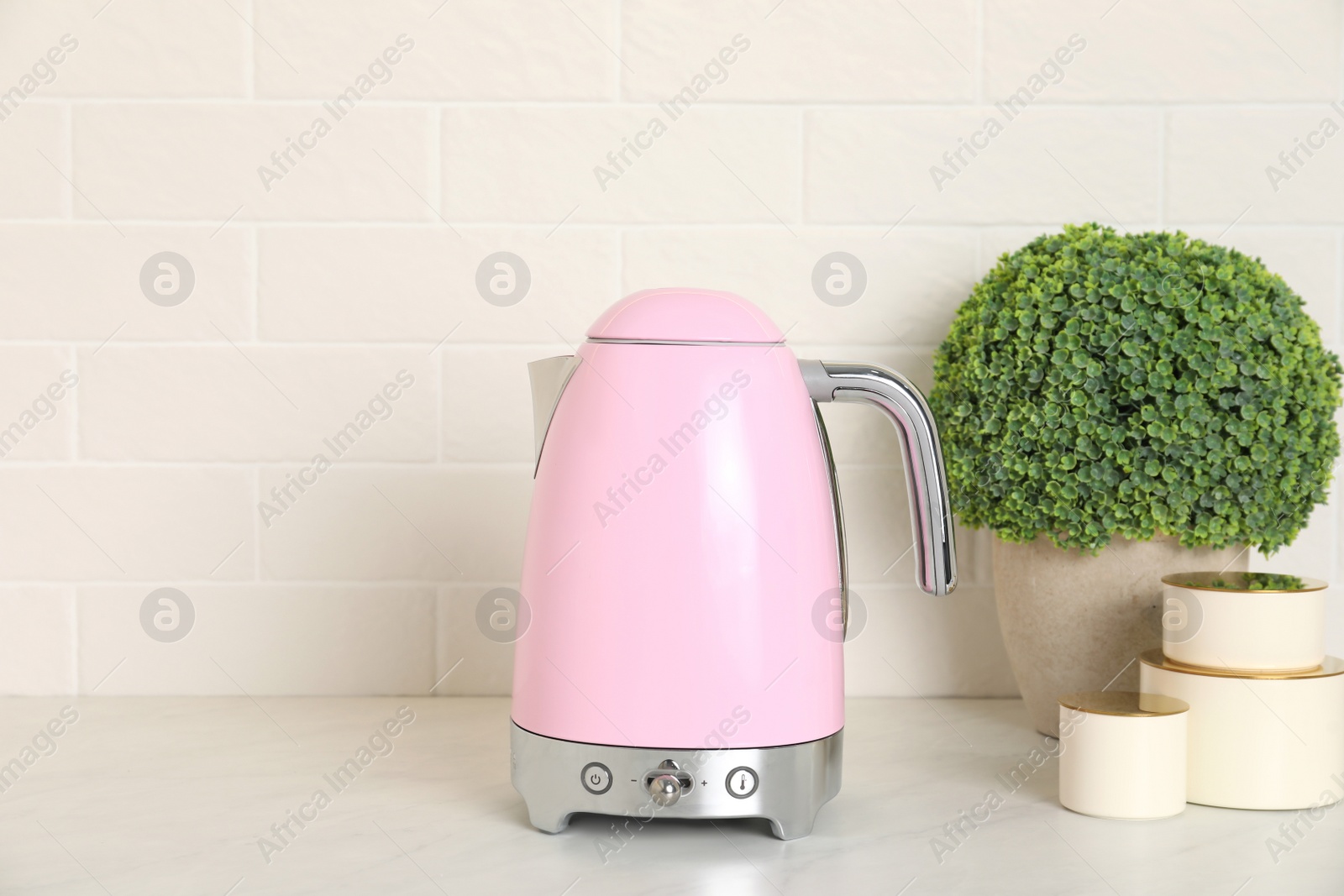 Photo of Modern electric kettle on counter in kitchen