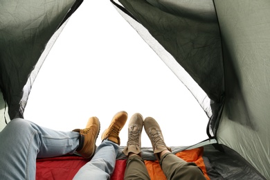 Photo of Closeup of couple in camping tent on white background, view from inside