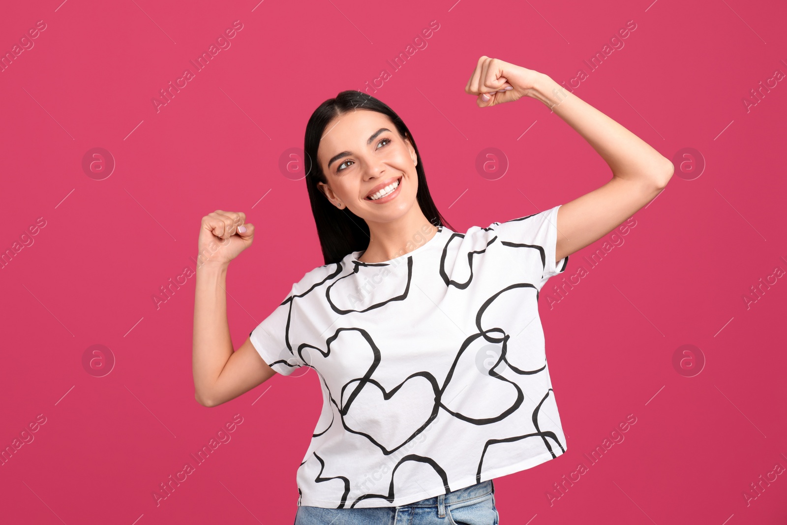 Photo of Strong woman as symbol of girl power on pink background. 8 March concept