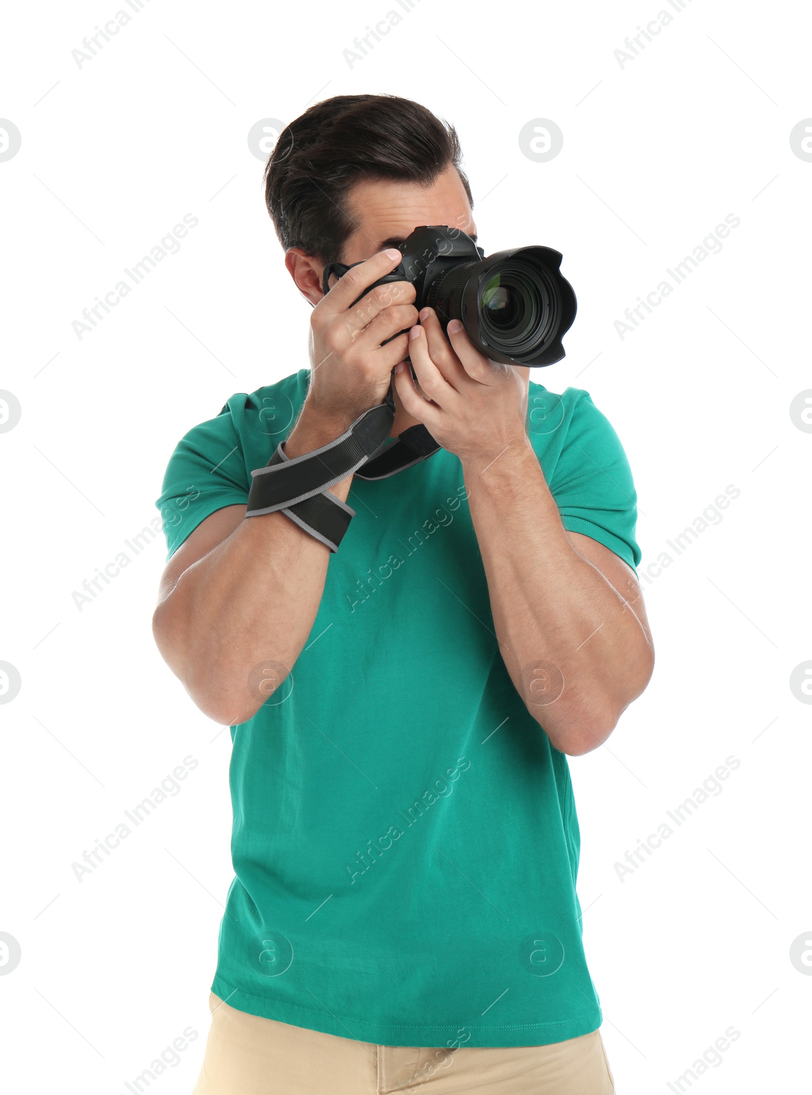 Photo of Young professional photographer taking picture on white background