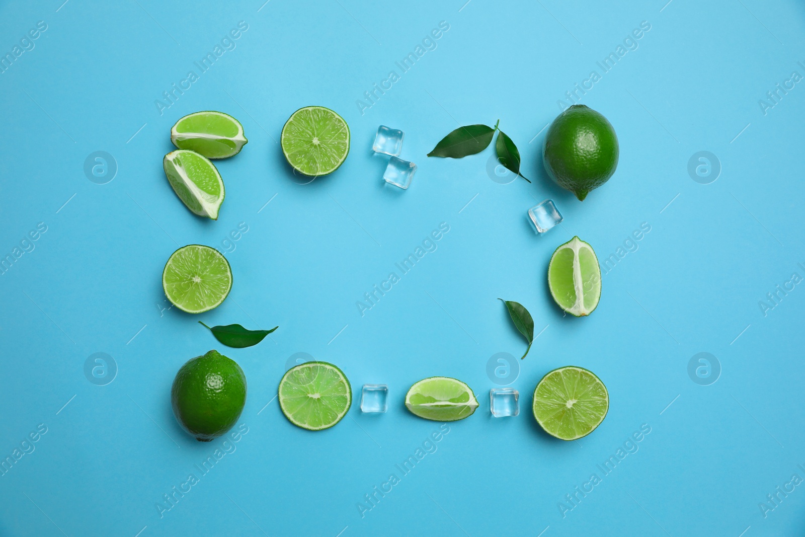 Photo of Flat lay composition with fresh juicy limes and ice cubes on light blue background. Space for text