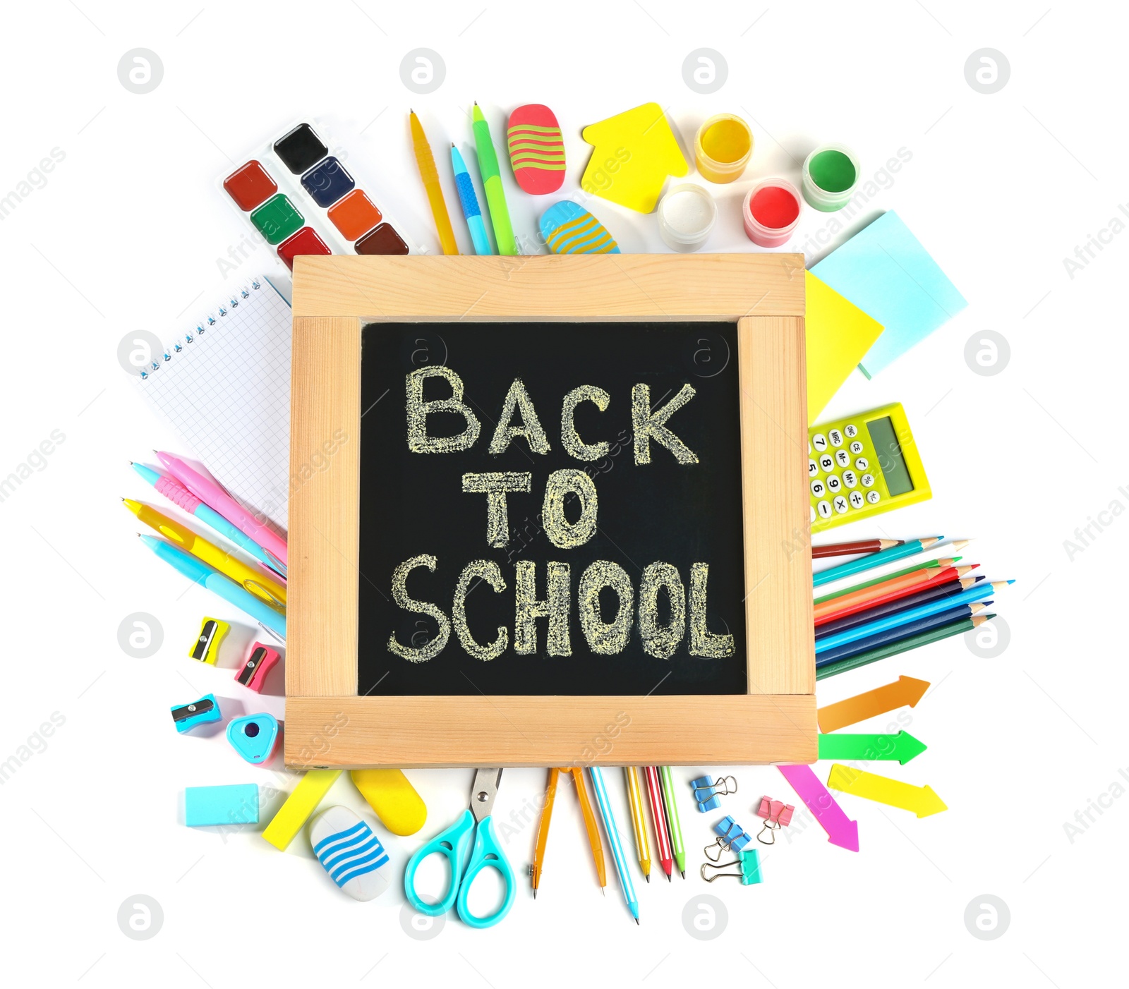 Photo of Chalkboard with phrase "BACK TO SCHOOL" and different stationery on white background, top view