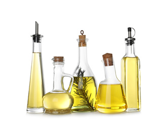 Photo of Different sorts of cooking oil in bottles isolated on white