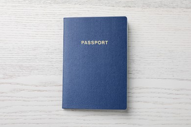 Photo of Blank blue passport on white wooden table, top view