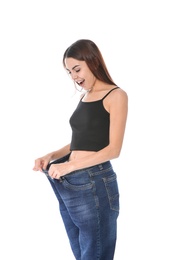 Photo of Slim woman in oversized jeans on white background. Weight loss