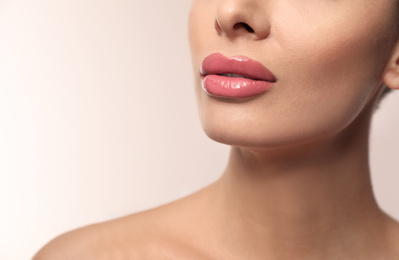 Photo of Woman with pink lipstick on light background, closeup