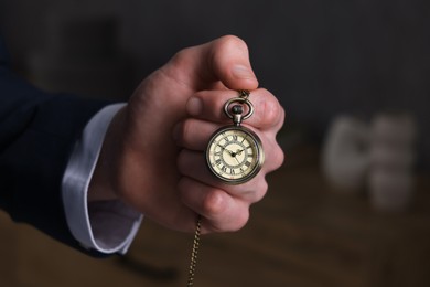 Man holding chain with elegant pocket watch, closeup. Space for text