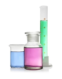 Laboratory glassware with colorful liquids on white background