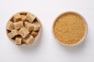 Photo of Different types of brown sugar in bowls on white table, flat lay