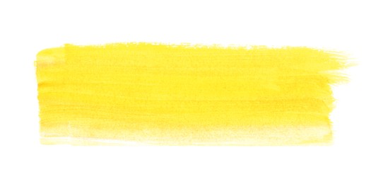 Yellow paint stroke drawn with brush on white background, top view