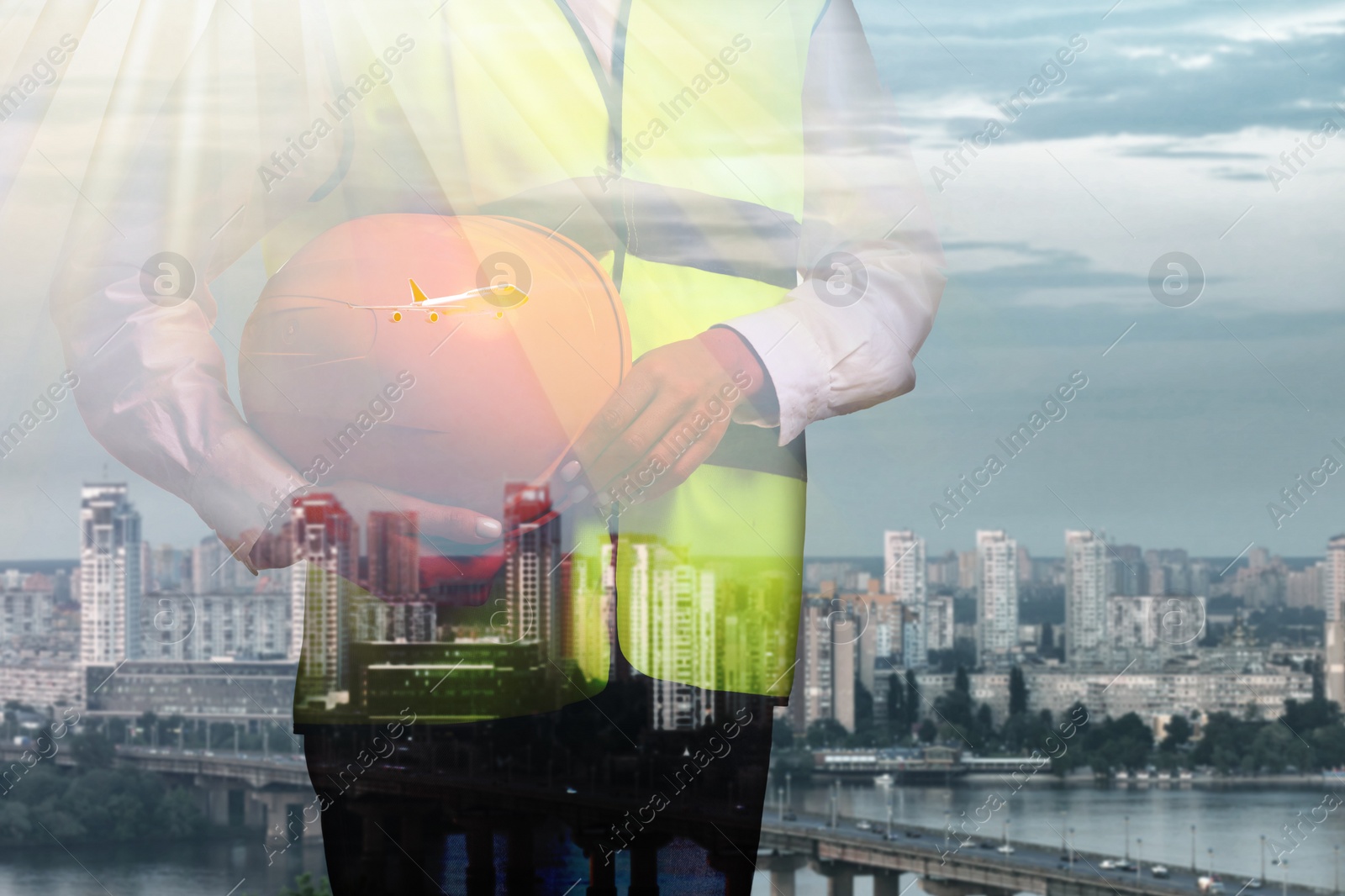 Image of Engineer with hard hat and cityscape, double exposure