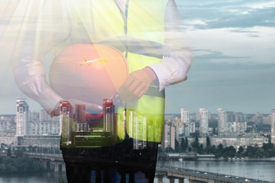 Image of Engineer with hard hat and cityscape, double exposure