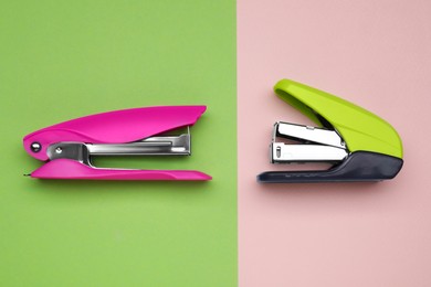 Photo of New bright staplers on color background, flat lay. School stationery