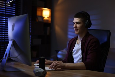 Man playing video games on computer at table indoors