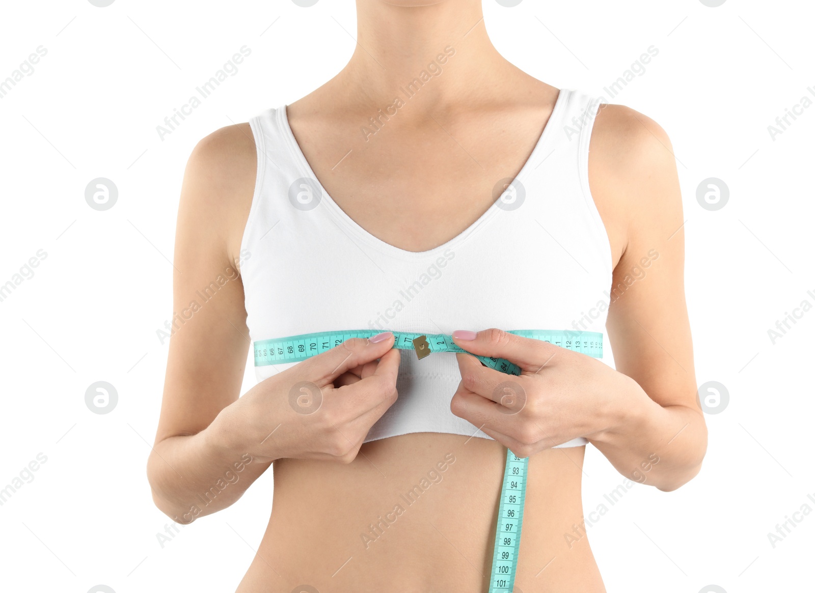 Photo of Young woman measuring breast size on white background, closeup. Cosmetic surgery