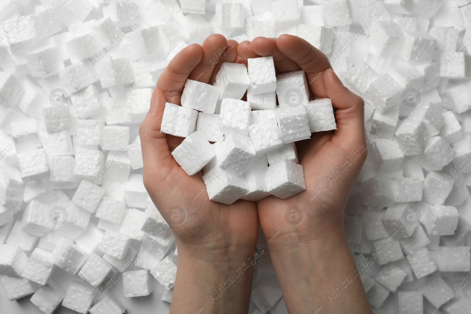 Photo of Woman with styrofoam cubes, closeup of hands