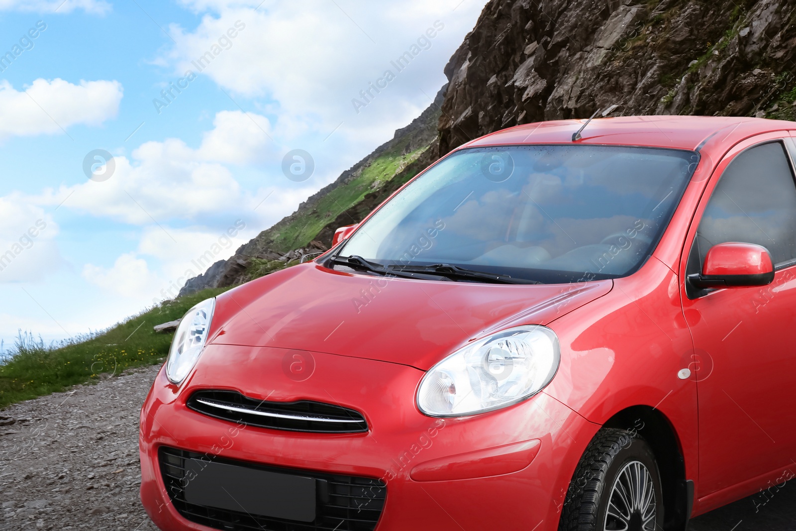 Image of Road trip. Car parked near mountains on cloudy day 