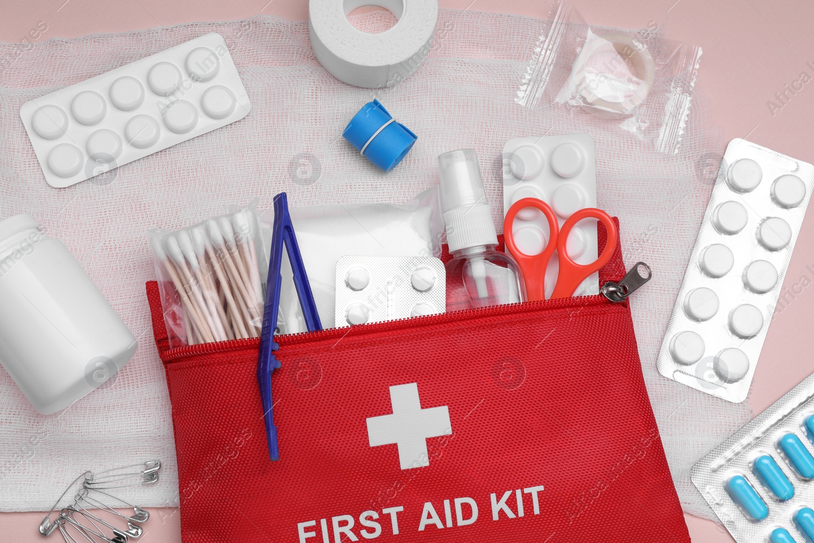 Photo of Flat lay composition with first aid kit on pink background