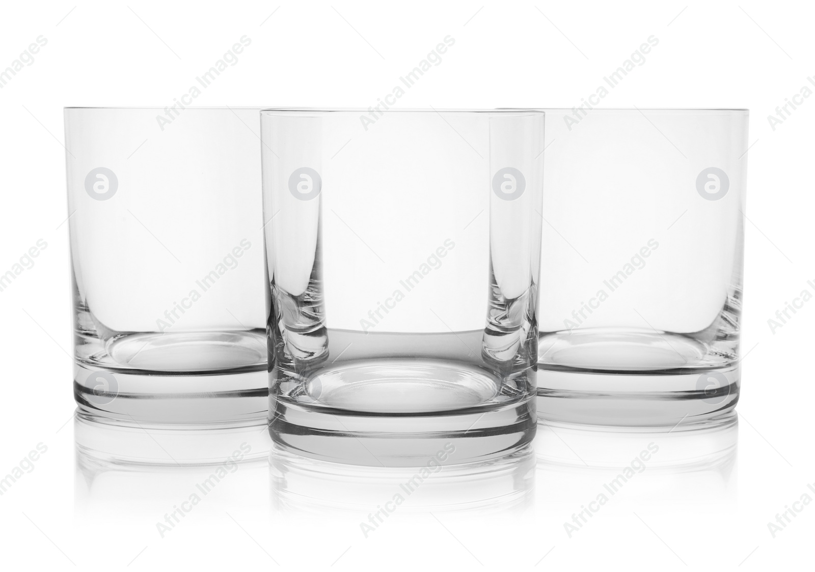 Photo of Empty clear lowball glasses on white background
