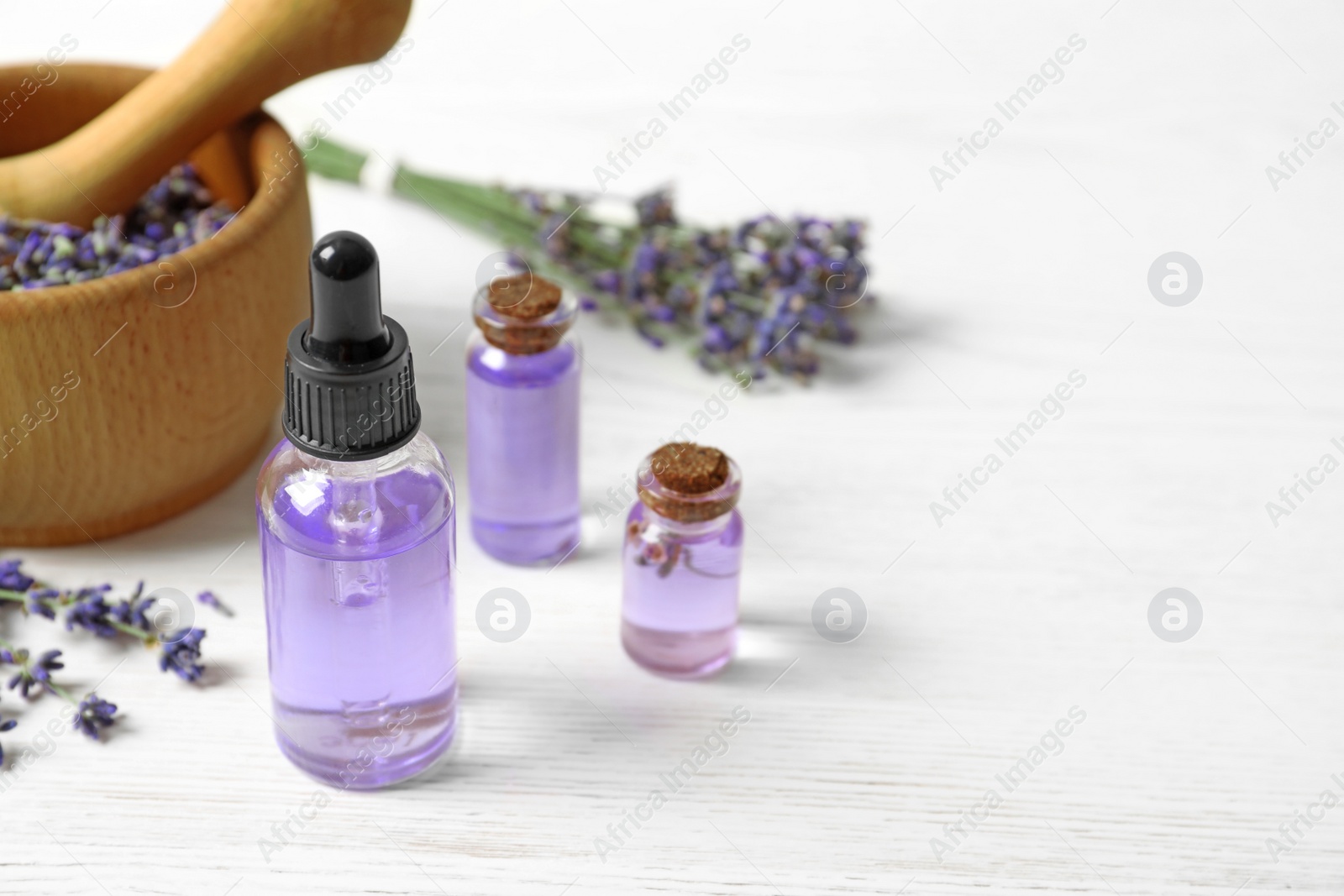 Photo of Composition with natural cosmetic products and lavender flowers on white wooden background. Space for text