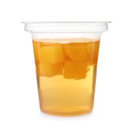 Tasty jelly dessert with slices of fruit in plastic cup on white background