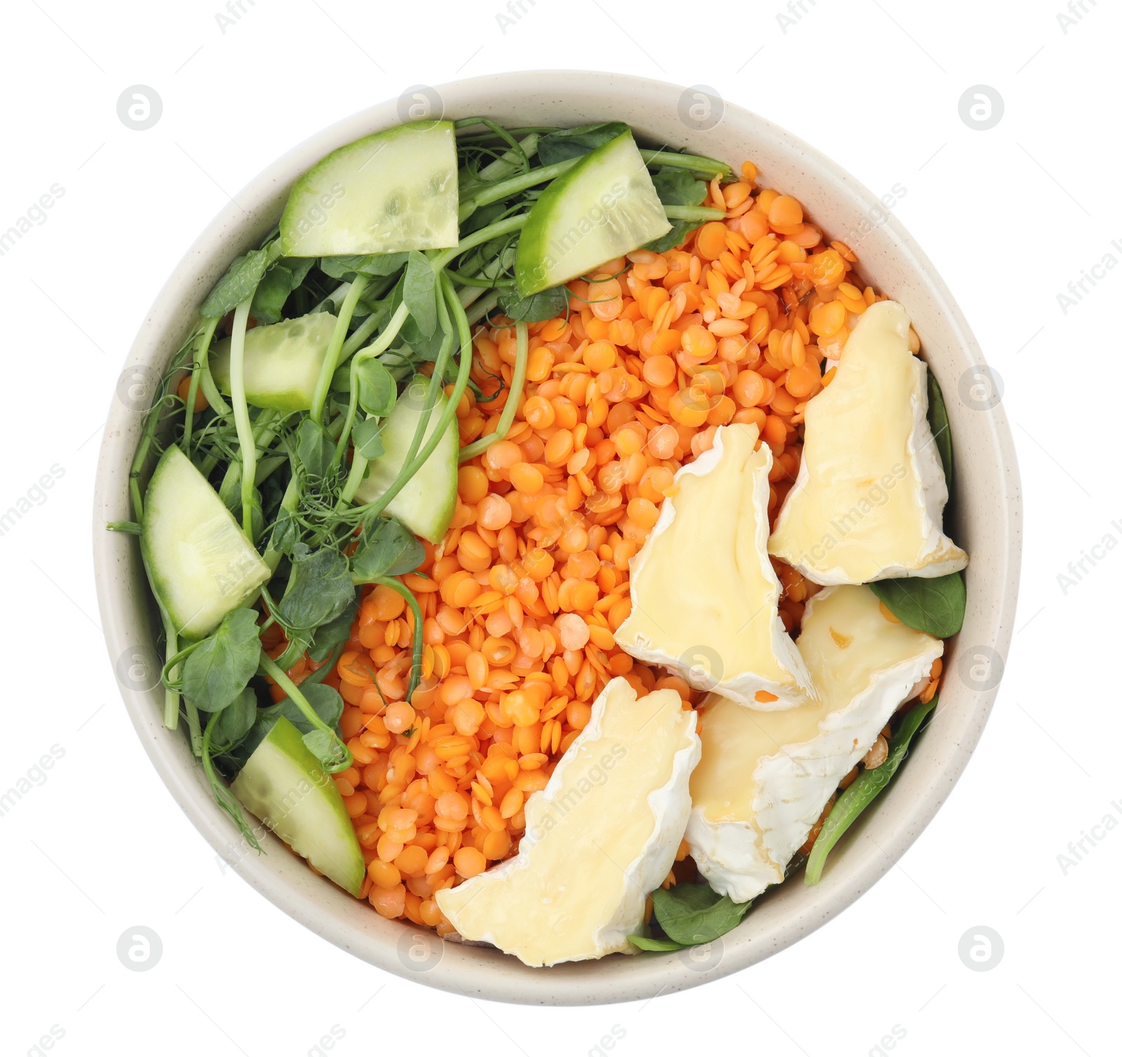 Photo of Delicious lentil bowl with soft cheese and cucumber on white background, top view