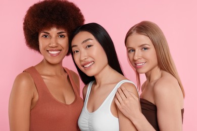 Photo of Portrait of beautiful young women on pink background