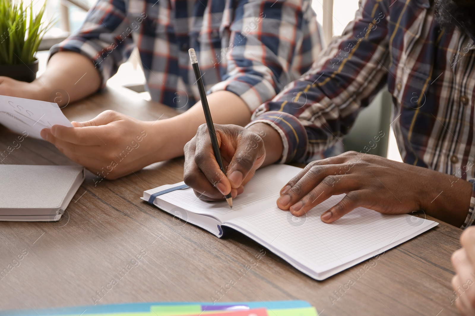 Photo of People working at table, closeup of hands. Unity concept