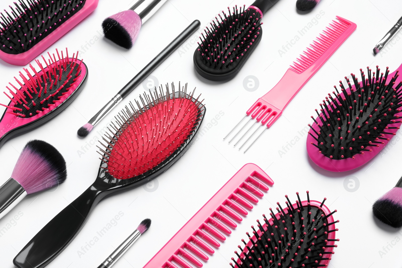 Photo of Composition with modern hair combs and brushes on white background, above view