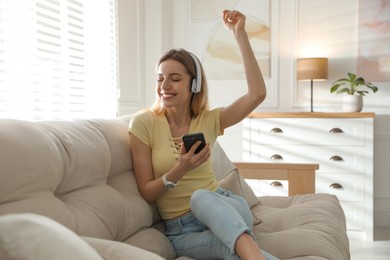 Young woman listening to music at home