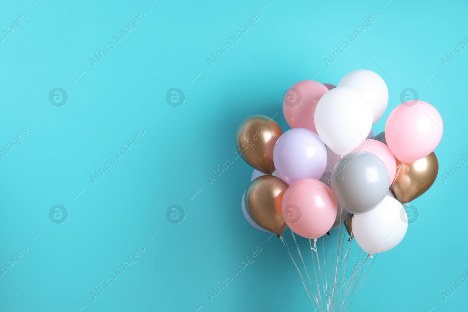 Photo of Colorful party balloons on blue background. Space for text