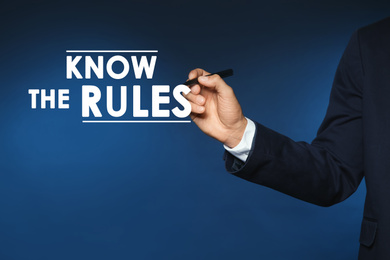 Image of Businessman using virtual screen with phrase Know the rules, closeup