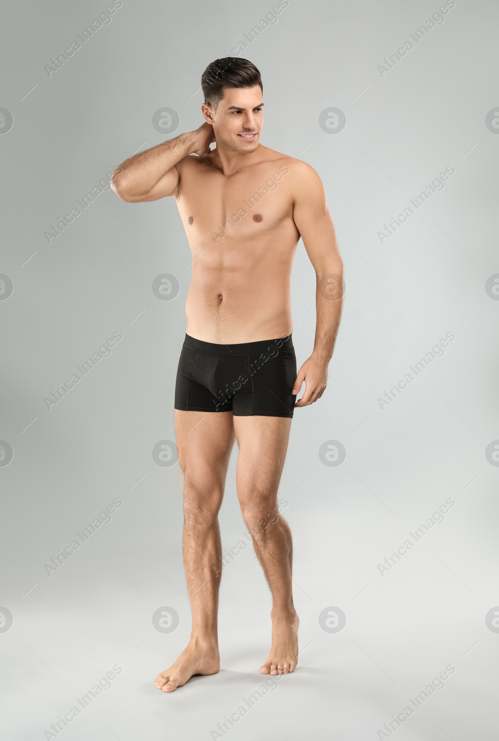 Photo of Handsome man in black underwear on light grey background