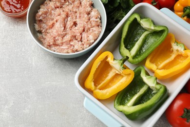 Photo of Making stuffed peppers. Vegetables and ground meat on grey table, flat lay. Space for text