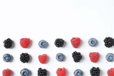 Composition with raspberries, blackberries and blueberries on white background