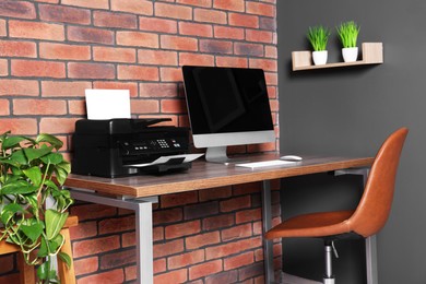 Stylish workplace with modern computer and printer at home