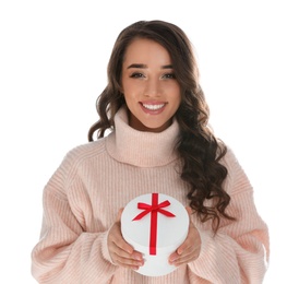 Beautiful young woman with Christmas gift on white background