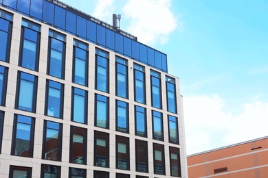 Photo of Modern building against blue sky, low angle view