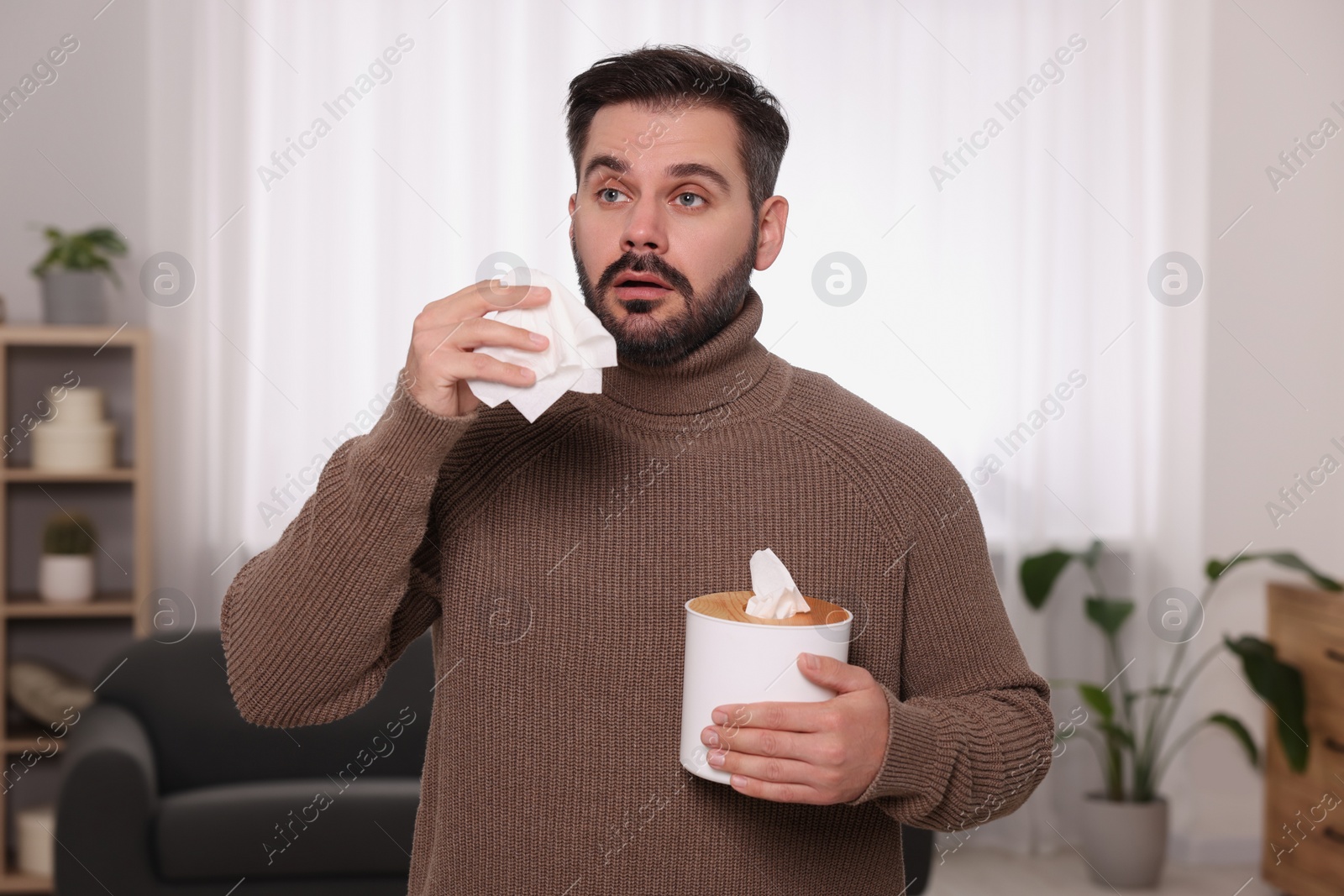 Photo of Sick man with tissues at home. Cold symptoms