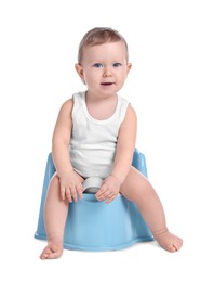 Photo of Little child sitting on baby potty against white background