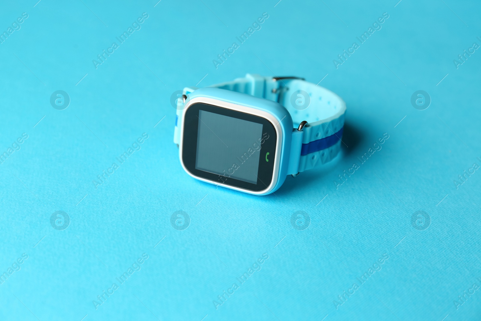 Photo of Modern trendy smart watch for kids on light blue background