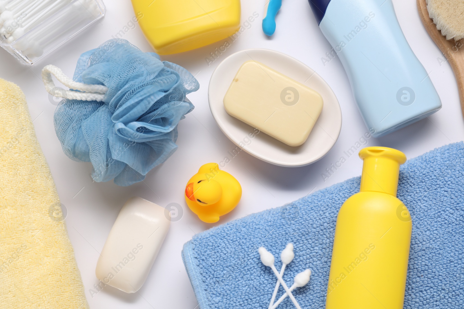 Photo of Different baby bath accessories and cosmetic products on white background, flat lay