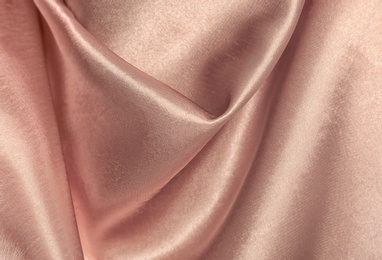 Photo of Texture of rose gold silk as background, closeup