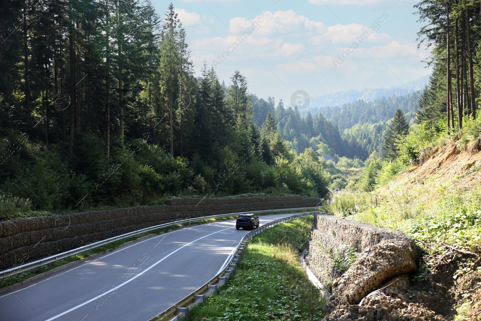 Photo of Picturesque view of asphalt road with modern car outdoors