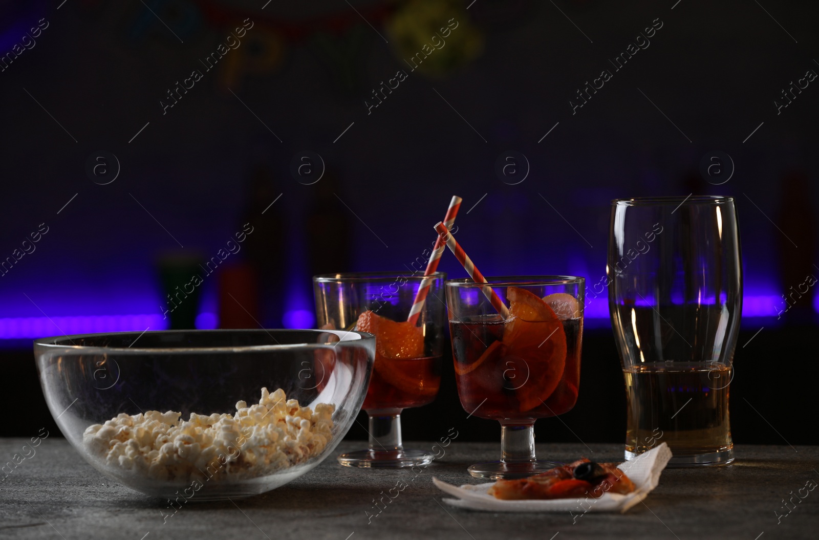 Photo of Messy table with drinks and food leftovers indoors. After party chaos