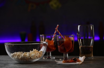 Photo of Messy table with drinks and food leftovers indoors. After party chaos