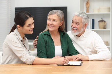 Notary consulting senior couple about Last Will and Testament in office