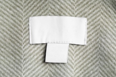Photo of Clothing label on striped garment, top view