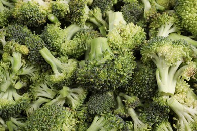 Photo of Fresh raw broccoli as background, closeup view