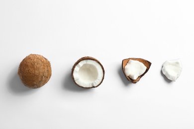 Composition with coconuts on white background, top view